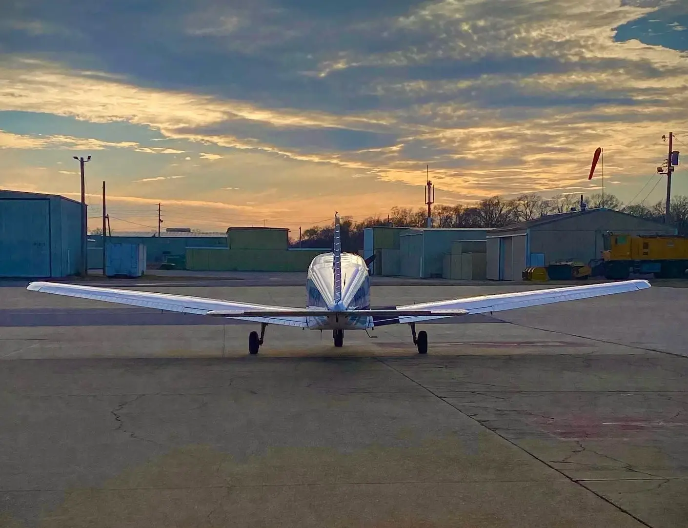 Airplane in airport at sunset