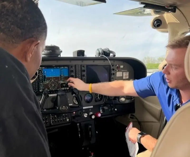 Flight instructor reviewing procedures with a student in the cockpit
