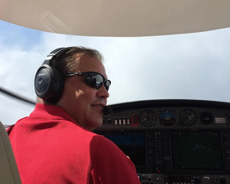 Pilot smiling for a picture in the middle of an IFR flight at Ideal Aviation