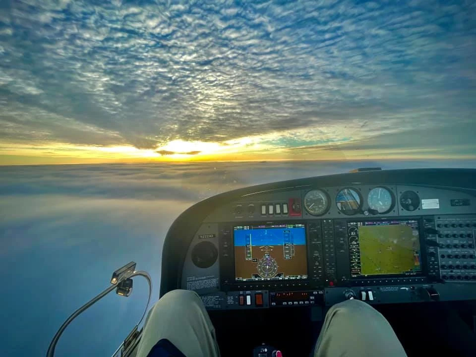 Clouds below and above seen from the pilot seat of an aircraft